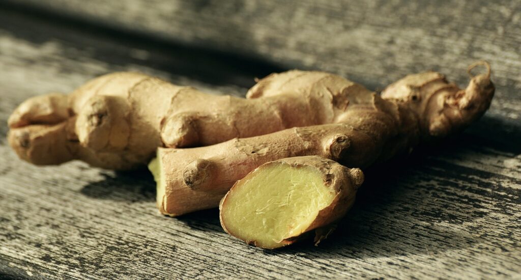 Fresh ginger root on a wooden surface, highlighting natural ingredients for wellness trends and immunity.